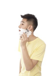 	portrait of young man shaving	