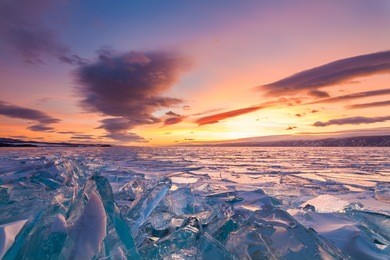 colorful sunset over the crystal ice of baikal lake