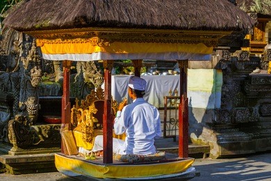 prayer in tirta empul temple on bali island indonesia - travel and architecture background