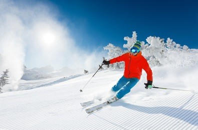 skier skiing downhill in high mountains