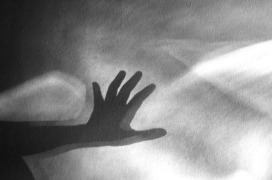 human hand shadow on vintage wall background