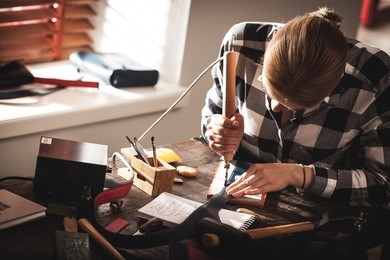 leather handbag craftsman at work in a workshop