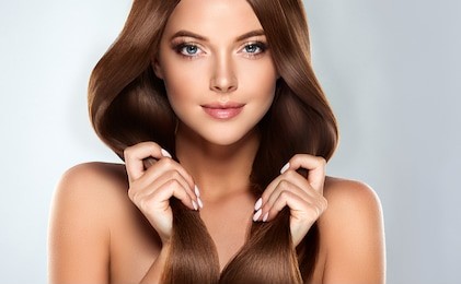 beautiful model girl with shiny brown straight long  hair . care and hair products .