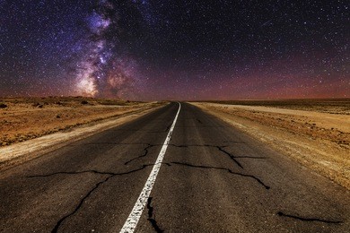 cracked desert road under the magnificent starry sky 
