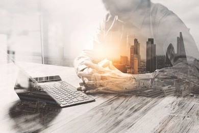 double exposure,businessman working with new start up project.using smart phone digital tablet docking keyboard on wooden desk,sun effect