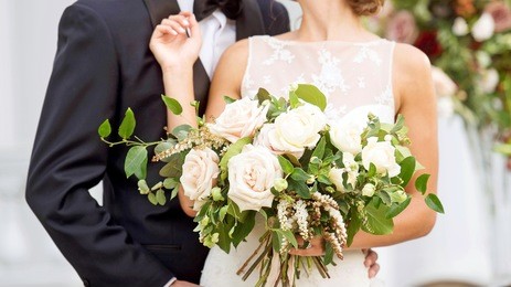 wedding couple with bride holding bouquet