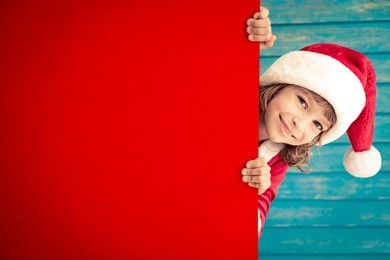 child holding empty banner. kid hiding behind card blank. christmas xmas winter holiday concept
