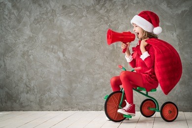 happy child rides a retro bike. kid playing at home. christmas xmas winter holiday concept