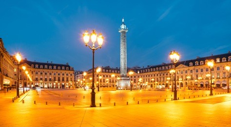 vendome column with statue of napoleon bonaparte, on the place vendome at night, in france. vendome column has 425 spiraling bas-relief bronze plates were made out of cannon.