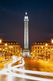 vendome column with statue of napoleon bonaparte, on the place vendome at night, in france. vendome column has 425 spiraling bas-relief bronze plates were made out of cannon.