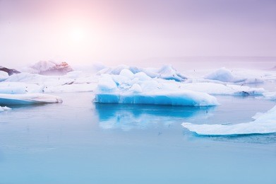 big blue icebergs in jokulsarlon glacial lagoon, south iceland. beautiful landscape at sunset.