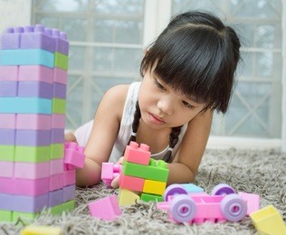 little girl playing with toy blocks . kids playing. child and toys