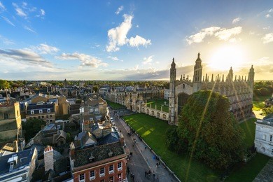 panoramic view of cambridge with sun flare at sunset, uk