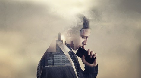 double exposure of a thoughtful bussinessman with a phone and a city view suggesting a very important decision.