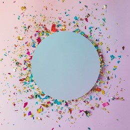 colorful celebration background with party confetti on pink background. flat lay.
