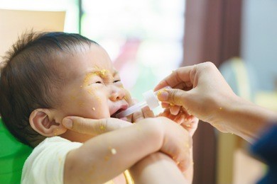 9 months old asian baby refuses eating medicine after meal