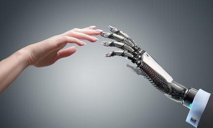robot gives a hand to a woman. two hands touching each other. artificial intelligence conceptual business design