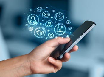 hand holding smartphone with glowing mobile app choices