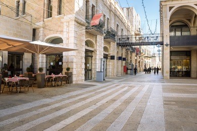 mamilla road street near jaffa gate of the old jerusalem city, israel. urban landscape with open cafe tables and beautiful walking street at sunny day. nice cozy street in the old town of jerusalem