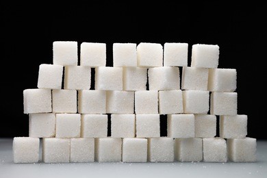 sugar cubes/ wall of sugar cubes on a black background