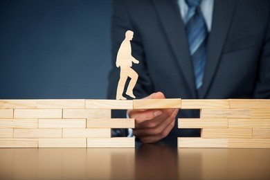 customer care, support (help) and life insurance concept. businessman representing company helps (support) customer (client) to overcome an obstacle. problem solving with smart and simple solutions.