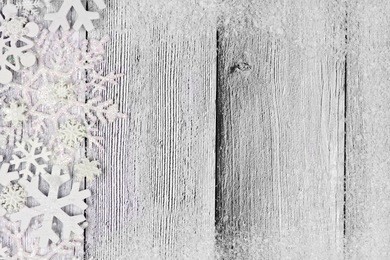 christmas snowflake side border with snow frame on rustic white wood background