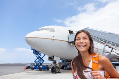 woman tourist getting out of airplane at airport. asian girl passenger walking out of stairs after plane landing arrival at airport at summer destination travel. tourism concept.