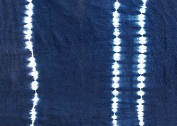 indigo tie dyed pattern on cotton fabric abstract background.
