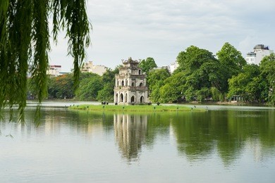 hoan kiem lake (sword lake, ho guom) in hanoi, vietnam with willow branches on foreground