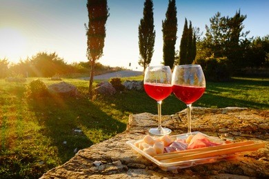 landscape of tuscany and two glasses of wine  