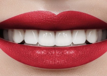 beautiful smile with whitening teeth. dental photo. perfect fashion lips makeup. health happy female smile. macro close-up shot of woman's mouth. care about tooth