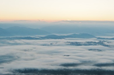 amazing picturesque landscape of carpathian mountains on fog and morning sunrise. beauty of world