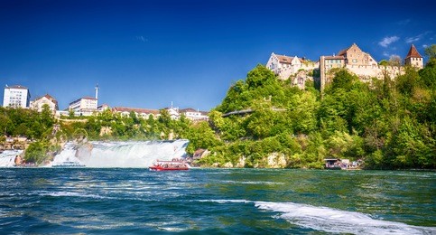 view to rhine falls (rheinfalls), the largest plain waterfall in europe.  it is located near the town of schaffhausen in northern switzerland, between the cantons of schaffhausen 