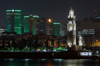 summer night view historical old montreal and the clock tower landmark along the ste-lawrence river in the old port, canada. 
