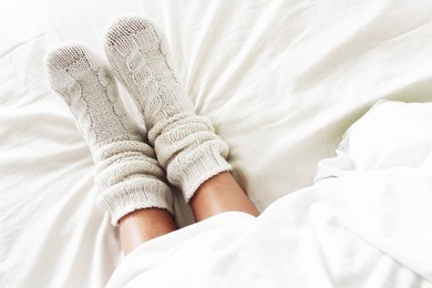 warm and cozy white socks in the bed