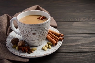 indian masala chai tea. spiced tea with milk on the rustic wooden table. selective focus, copy space.