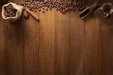cup of coffee and ingredients on wooden background