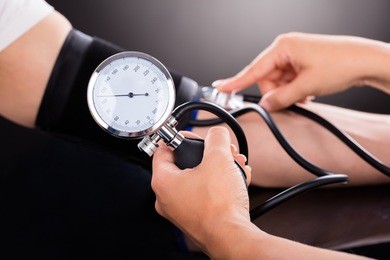 close-up of a doctor checking blood pressure o patient