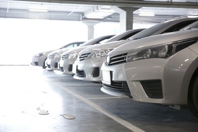 parking garage, interior with a few parked cars.