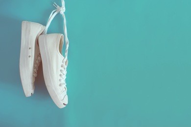 white sneakers on light blue background.toned image.