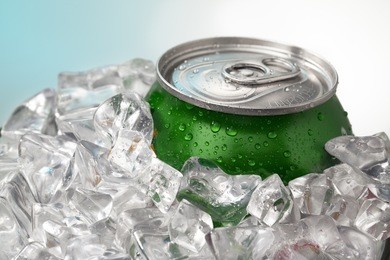 can of soda pop in ice showing cold refreshing drink in the summer