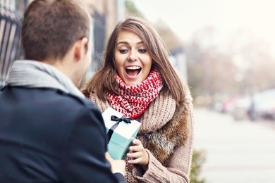 picture showing young couple with present in the park