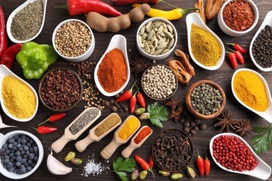 herbs and spices on dark wooden background. aromatic ingredients and natural food additives.