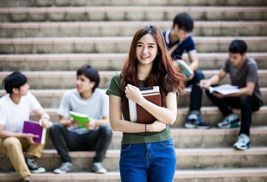 group of happy teen high school students outdoors