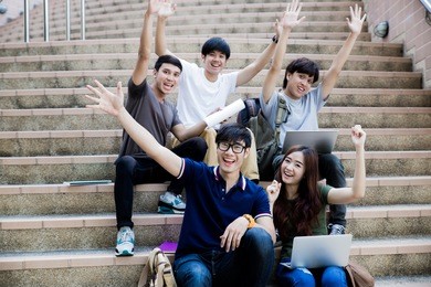 group of happy teen high school students outdoors