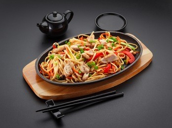 asia food. udon noodles with chicken on the black table.