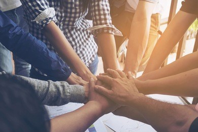 business people join hand together during their meeting