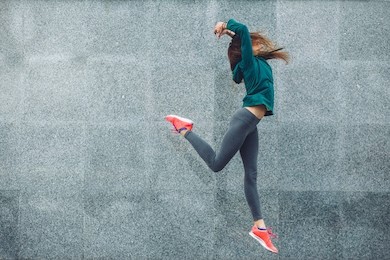 fitness sport girl in fashion sportswear dancing hip hop in the street, outdoor sports, urban style