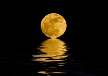 full moon over night water