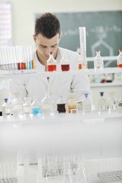young man scientist in chemistry bright lab